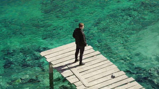 Lonely guy on the sea border  4K wallpaper