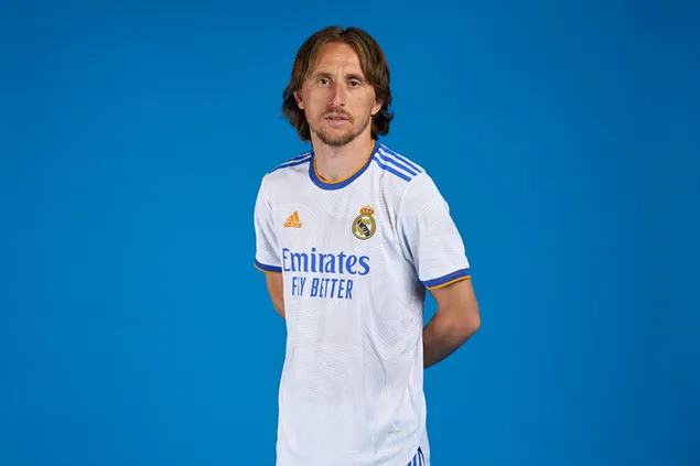 Luka Modric, Real Madrid's Croatian national football player, poses with his hands behind his back in front of a blue background download