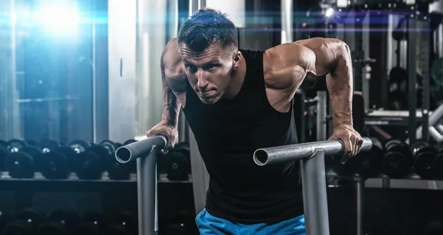 Man working out in the gym develops his muscles 4K wallpaper