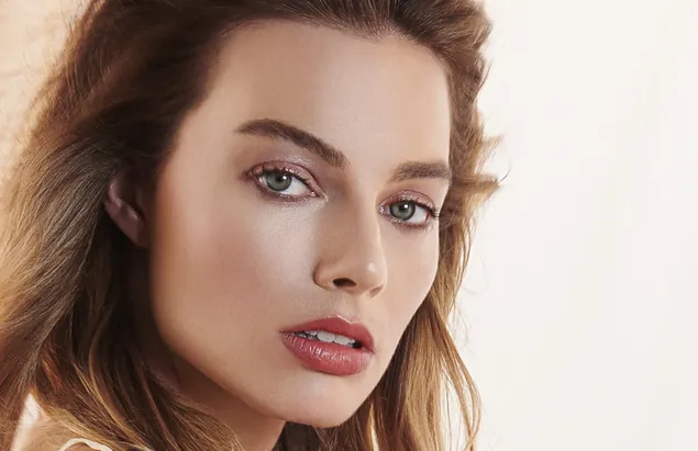 Páipéar balla Margot Robbie aghaidh álainn le liopaí dearg súile gorm, gar suas lámhaigh aghaidh4K