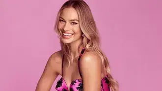 margot robbie bright pink studio portrait with joyful smile and glamour styling