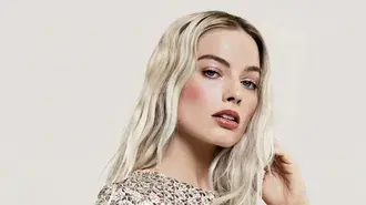 margot robbie elegant studio beauty portrait with platinum hair and sparkling dress