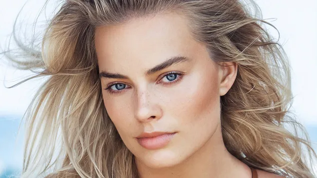 Margot Robbie se pragtige blik met haar deurmekaar blonde hare en blou oë 2K muurpapier