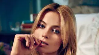 margot robbie soft cinematic close up portrait with warm tones and dreamy bokeh