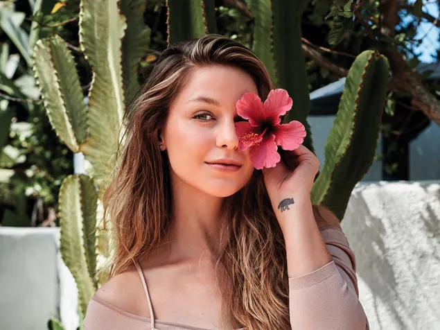 Melissa Benoist holding a Rosemallows with cactus background