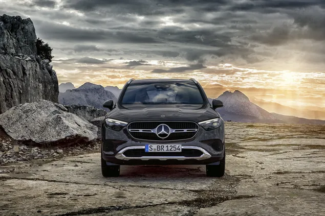 Mercedes-Benz GLC 300 in black among earthen ground and cliffs reflecting clouds and sunlight