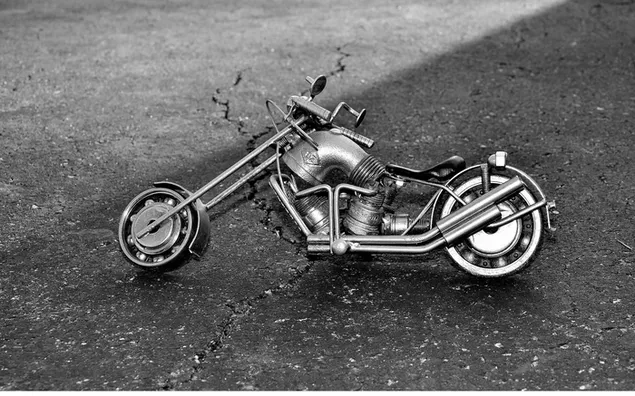 Metal design motorcycle on half light half shaded road on black and white ground