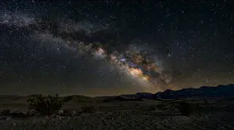 Milky Way Majesty Over Mountains: A Starry Night Landscape 4K wallpaper