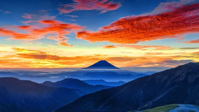 Mists between mountain silhouettes and hills under red clouds 8K wallpaper