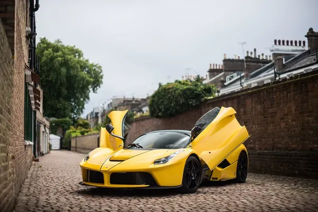 Modern design gele Ferrari LaFerrari Aperta ziet er geweldig uit met stalen wielen geparkeerd op stenen weg tussen gebouwen 2K achtergrond