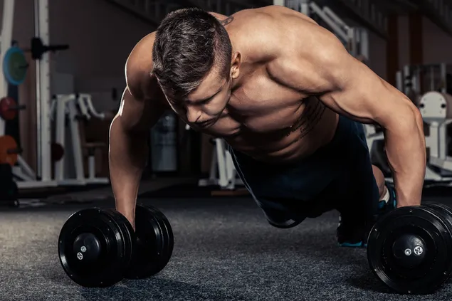 Muscular handsome man working out push-ups on dumbbells in gym 2K wallpaper