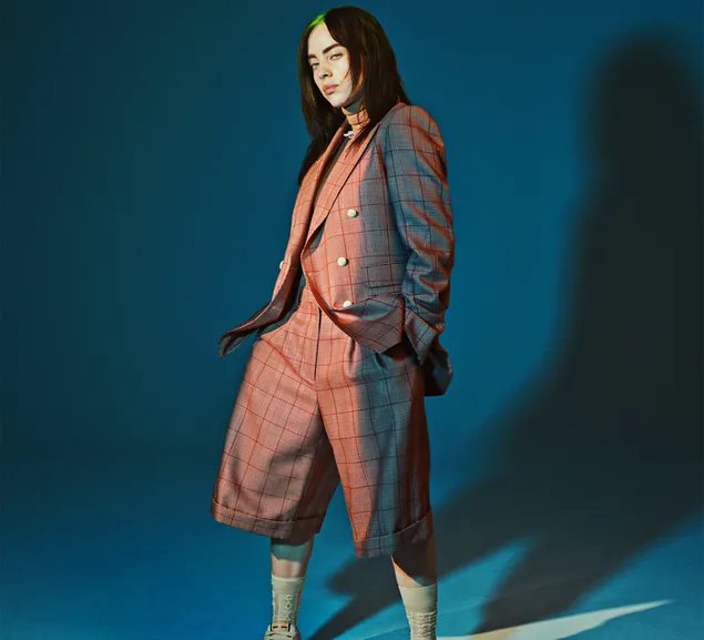 Musician Billie Eilish wearing suit with blue background photography