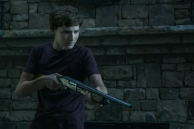 Ozark - Skylar Gaertner as Jonah Byrde holding a gun
