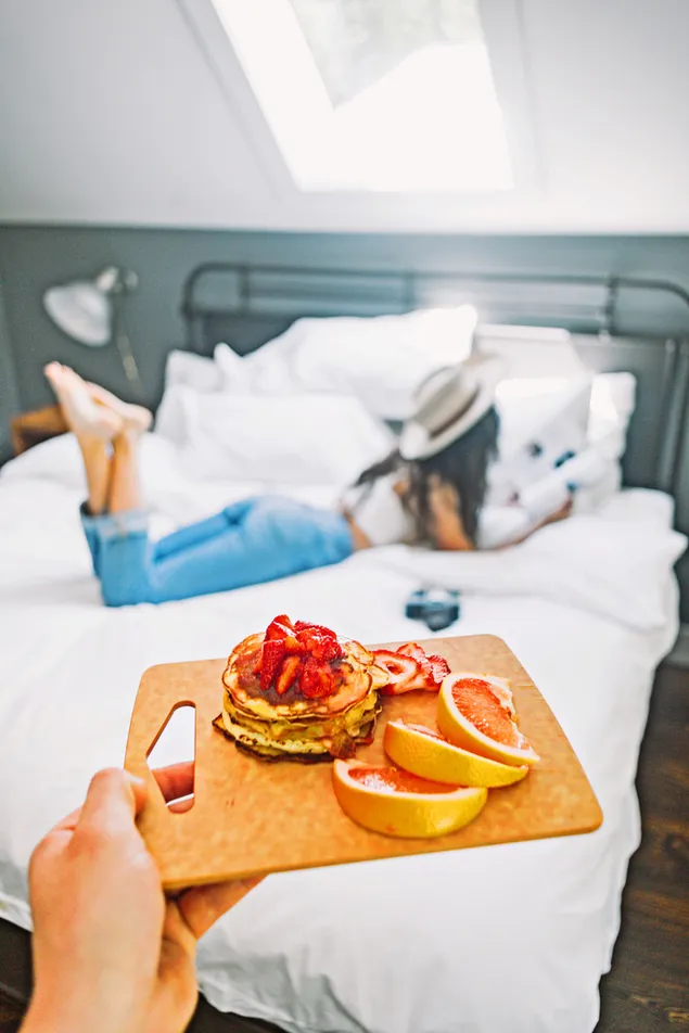 Pancake top with Strawberry and Grapefruit on the side with a girl background