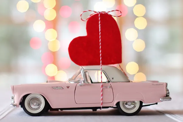 Pink Thunderbird miniature car tied up with a heart  download
