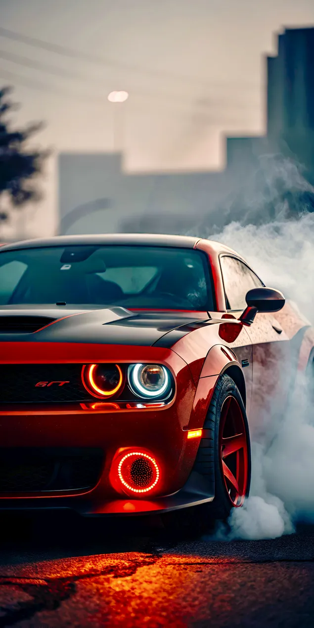 vykonne cervene sportovni auto provadi dramaticky burnout s intenzivnimi kourovymi a svetelnymi efekty stahnout