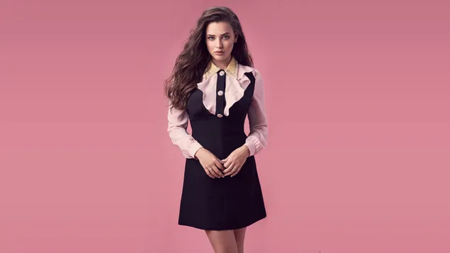 Pretty formal Katherine Langford with pink wallpaper background
