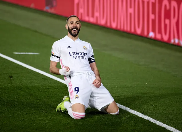 De Algerijns-Franse spits Karim Benzema van Real Madrid viert feest op het groene gras van het stadion na het doelpunt