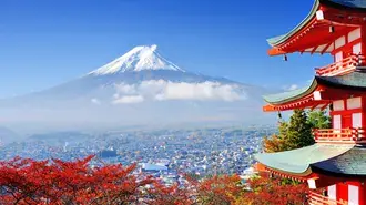 Red color architectural building and view of trees in red autumn colors overlooking snowy mountain tress 4K wallpaper