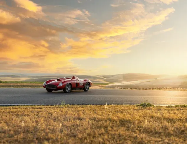 Red Ferrari 410 Sport Spider and sunset view