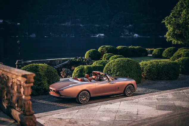 Rolls Royce, an open-top technological wonder parked in a garden on the slopes of the mountains and the sea