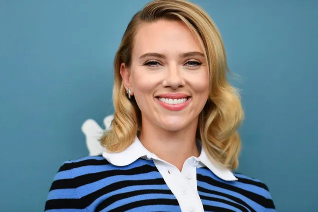 Scarlett johansson wavy blonde hair with a blue black and white collar outfit