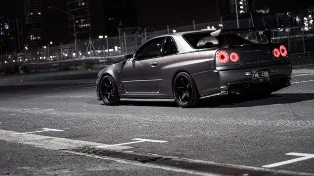 Silver nissan skyline gt-r r34 on the road at night download