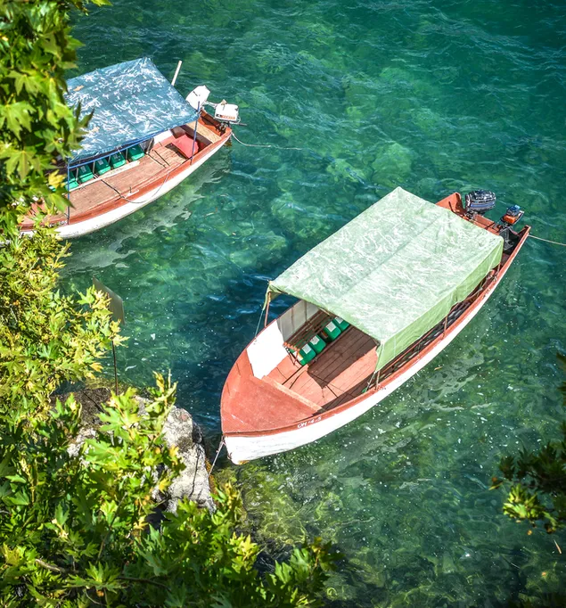 Small boat in the lake from above