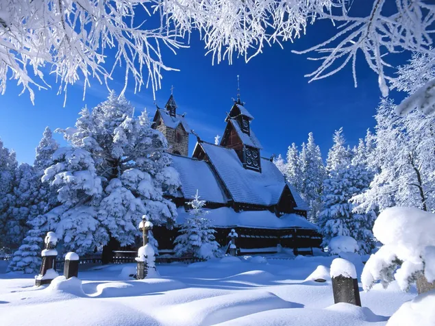 Iglesia cubierta de nieve en el bosque