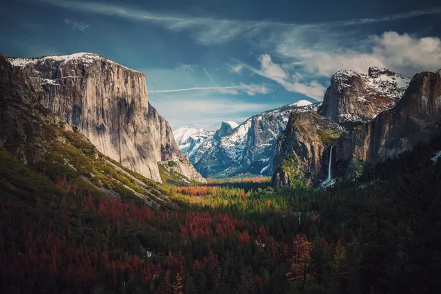 Snowy mountains, hills and green red plants with a view of the cloudy sky 8K wallpaper