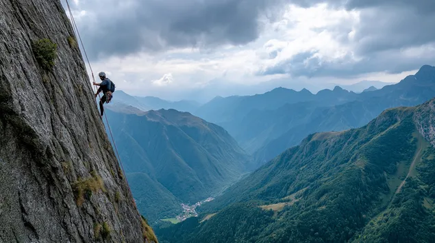 pendaki sendirian di tebing terjal di atas pemandangan lembah unduhan