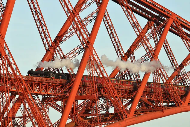 Steam train moving on the red iron bridge with its magnificent design 4K wallpaper