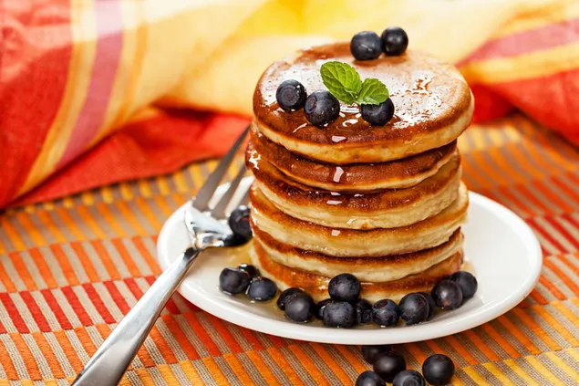 Sweet breakfast a stack of pancakes with maple syrup and blueberries