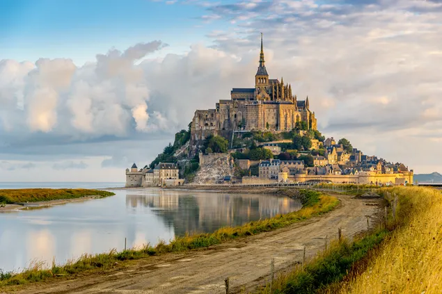 This historic Mont-Saint-Michel with its beautiful scenery is remarkable with its dirt road and reflections.
