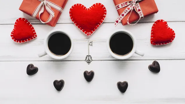 Two coffe betwwen hearts and gifts for valentine's day