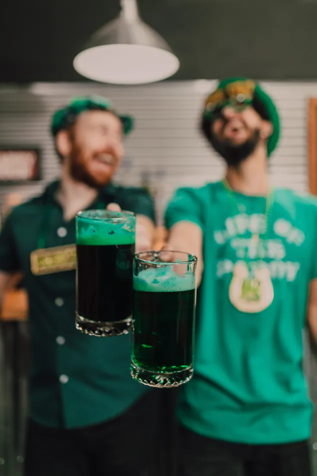 Two mans from Ireland, looking happy and drinking special drink for Saint Patrick's Day
