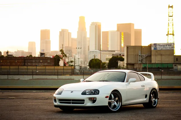 White Toyota Supra parked in the city 2K wallpaper
