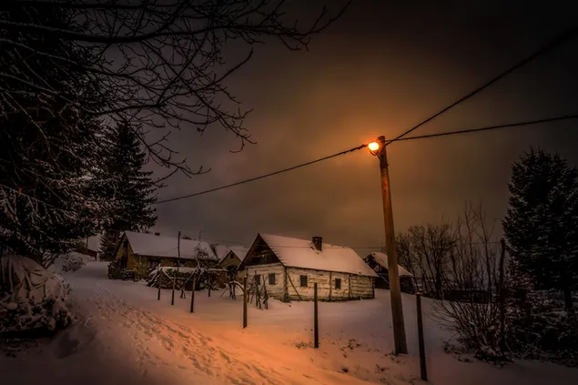 Winterdorp bij nacht HD achtergrond