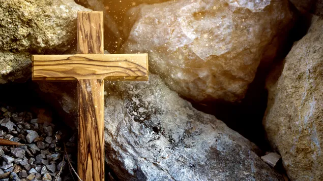 Wooden Cross besides stones and rocks, download
