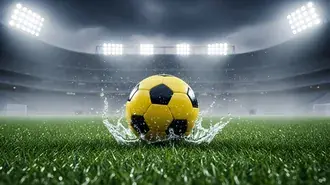 yellow and black soccer ball splashing water on a rainy green grass field under bright stadium lights. download